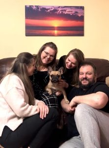 Tina the French Bulldog surround by 4 family members after being reunited.